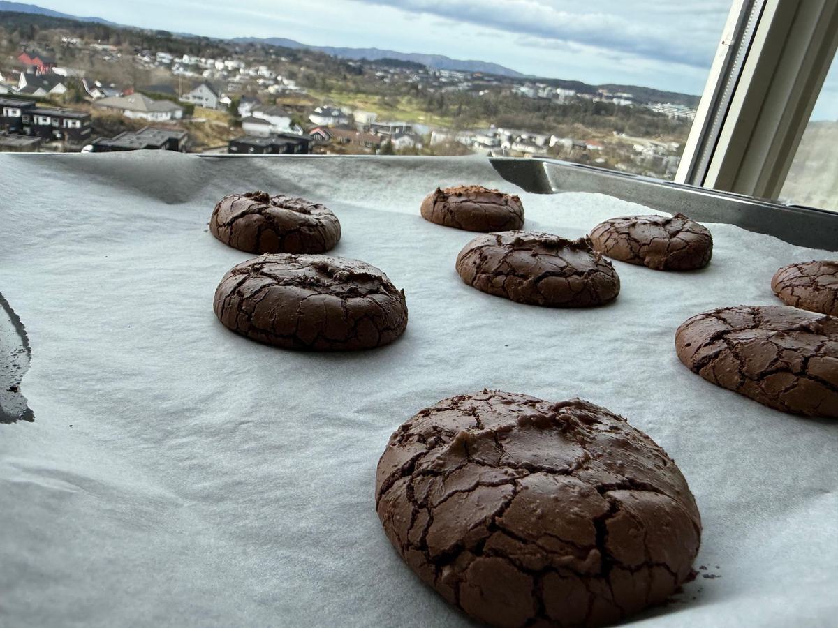 Full brett med nybakte Husets Kjeks, med Bergen og fjellene i bakgrunnen